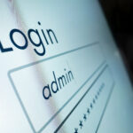 Illustration showing a legacy Windows app window with an admin warning badge, a security lock, and a checklist of fixes for least privilege and removing local admin rights.